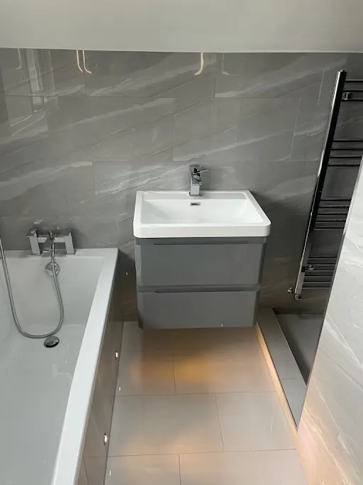 Bathroom installation with wall-hung grey vanity and heated towel rail, Bexley