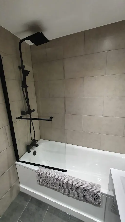 Bathroom installation with matte black shower fixtures and glass screen, Bexley