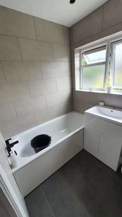 Bathroom installation with bath and black tap, Bexley
